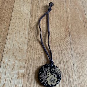 Lacquered wooden medallion necklace with gold painted detail